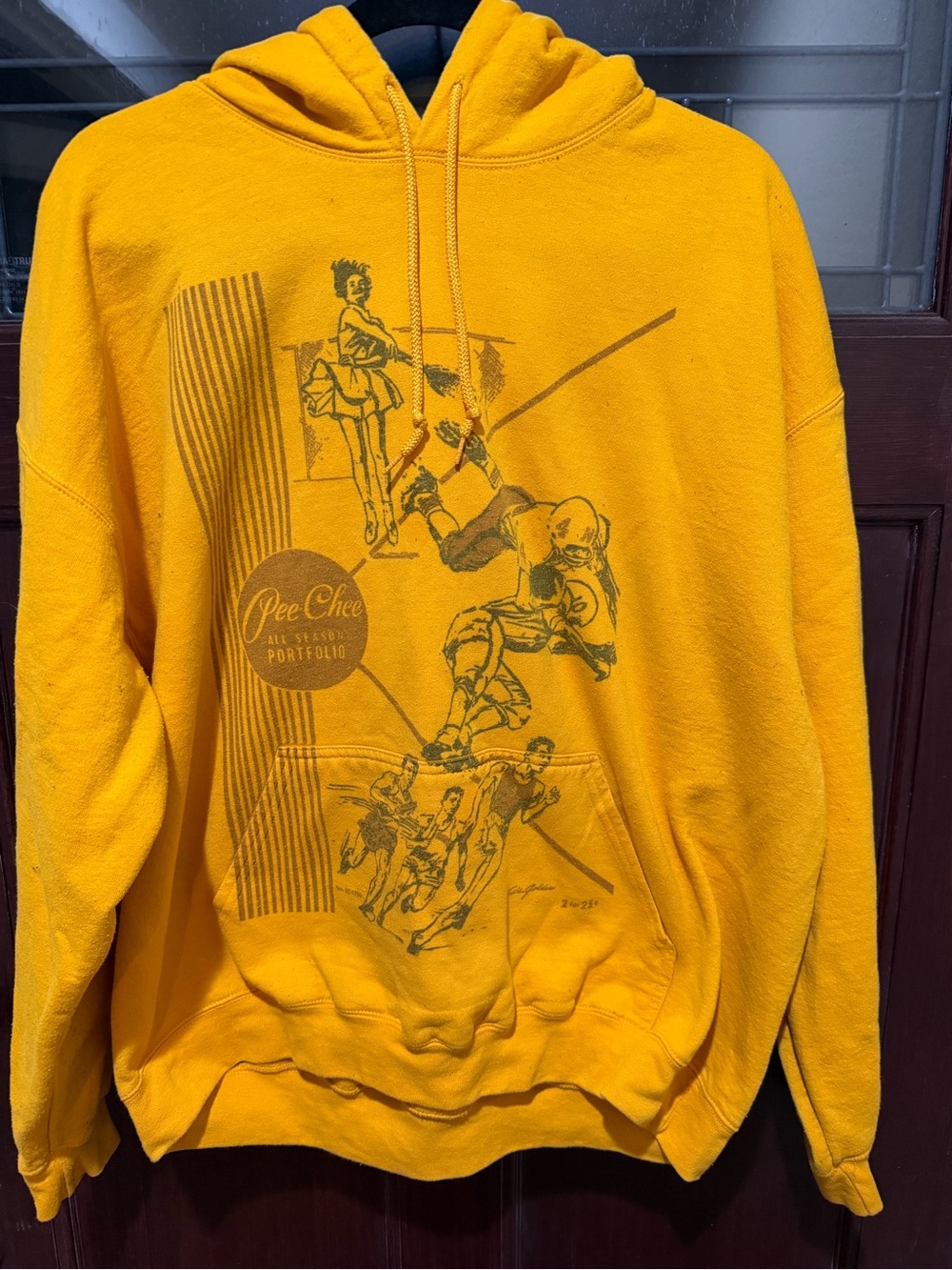 Infamous PeeChee Yellow Graphic Hoodie with Vintage Sports Illustration